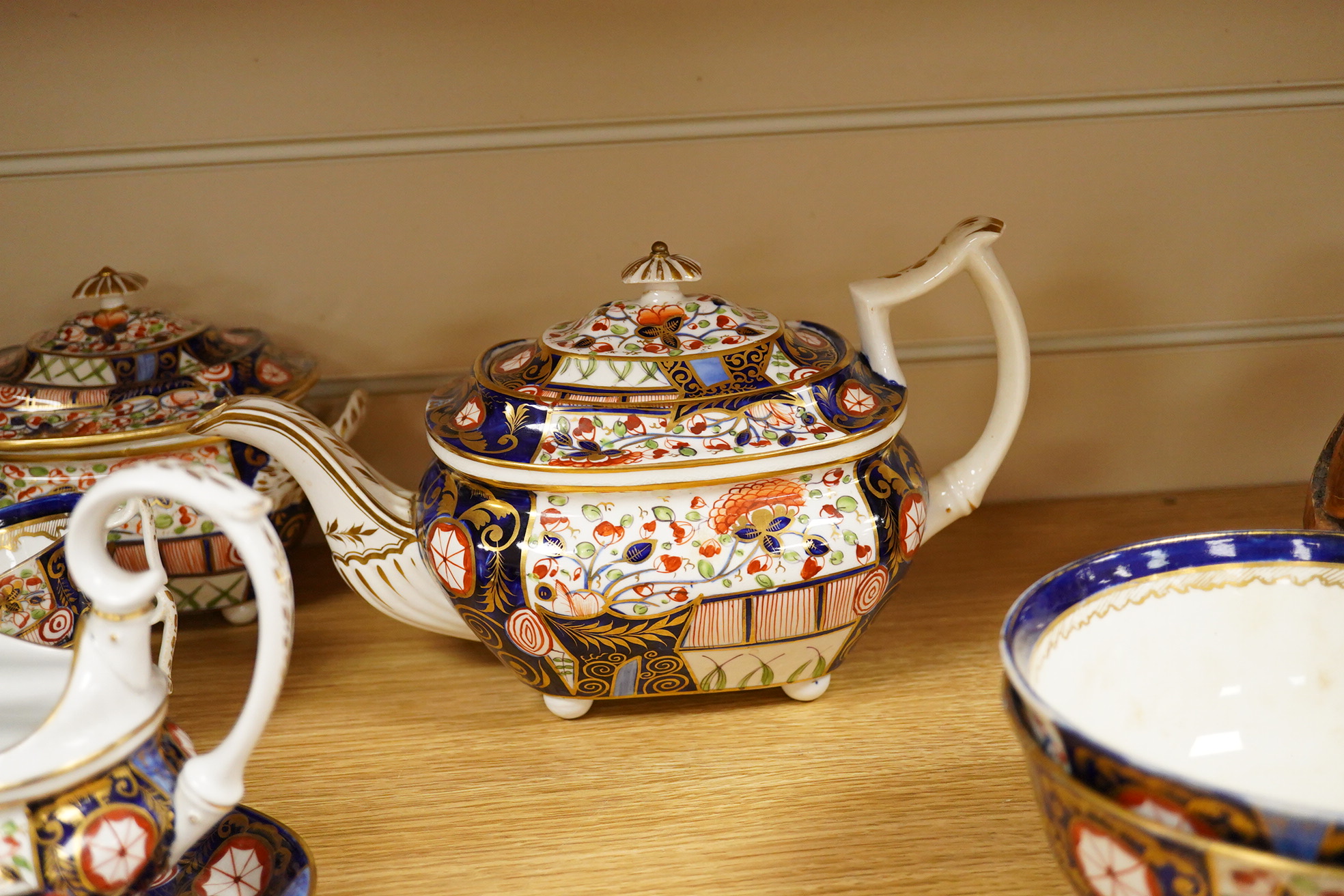 A 19th century Derby Imari pattern part tea set including a teapot a pair of 19th century botanical dishes and six small ironstone dishes.